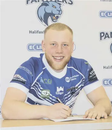  ??  ?? SIGNING ON: Will Calcott pens his new contract at Halifax Panthers.