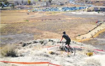  ??  ?? Garrison Hayes, a senior at Cherokee Trail High School, has raced in the Colorado High School Mountain Bike League for four years, despite losing a portion of his leg from a cancerous bone tumor in 2005. Photos by Jason Blevins, Special to The Denver...