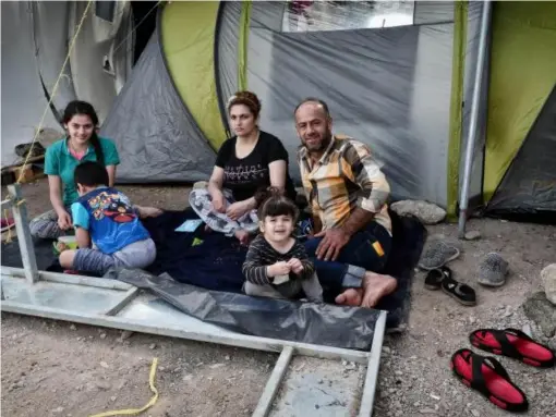  ?? (AFP/Getty) ?? A Syrian family from Aleppo newly arrived to Greece sits in a makeshift camp