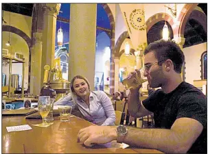  ?? AP/DAKE KANG ?? Jesse Hulien has a beer with Molly Hartman at the bar at Church Brew Works, a Pittsburgh sanctuary renovated into a brewery.