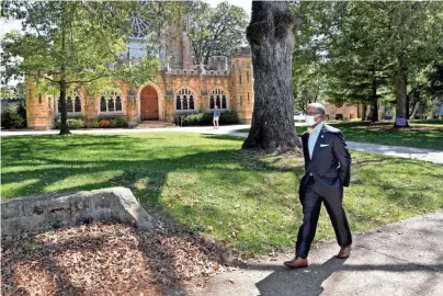  ?? PHOTOS BY LARRY MCCORMACK/THE TENNESSEAN ?? President and Vice Chancellor Reuben E. Brigety II is the first African American to serve in that post at The University of the South. He walks past the most impressive building on campus, All Saints Chapel, on Sept. 22.