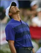  ?? DAVID DERMER — THE ASSOCIATED PRESS ?? TigerWoods reacts after missing a putt on the 18th hole during the second round of the Memorial golf tournament Friday in Dublin, Ohio.