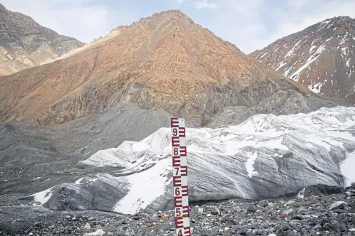  ??  ?? LEFT A measuring rod stands at the foot of the Mengke Glacier, which is being monitored by researcher­s from the Chinese Academy of Sciences, in Subei County in Gansu province. BELOW The remains of a home destroyed by severe flooding caused by heavy...