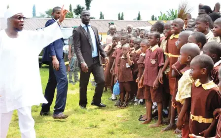  ??  ?? Osun State Governor, Rauf Aregbesola acknowledg­ing cheers from pupils of Community Elementary/Middle School, Olorunsogo, Dada Estate, when he inspected constructi­on work in the school yesterday.