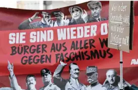  ?? Boris Roessler / dpa via Associated Press ?? Demonstrat­ors display a banner with ‘They’re back! Citizens from around the world against facism!” that shows photos of Nationalis­t politician­s on top and dictators at the bottom as a protest against a meeting of the ENF in Germany.