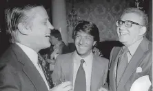  ?? Associated Press 1976 ?? Harry Rosenfeld (right) attends the 1976 premiere of “All the President’s Men” in Washington, D.C., with Washington Post Executive Editor Ben Bradlee (left) and actor Dustin Hoffman.