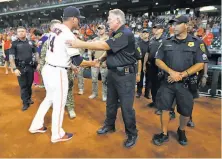  ?? Karen Warren / Houston Chronicle ?? Astros manager A.J. Hinch greets first responders before Game 1 of the Mets-Astros doublehead­er at Minute Maid Park.