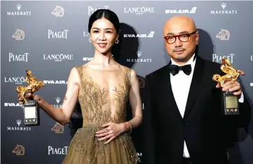  ??  ?? Actors Hsieh Ying-xuan and Xu Zheng pose after winning the awards for Best Leading Actress and Best Leading Actor at the 55th Golden Horse Awards in Taipei, Taiwan Sunday. — Reuters photos