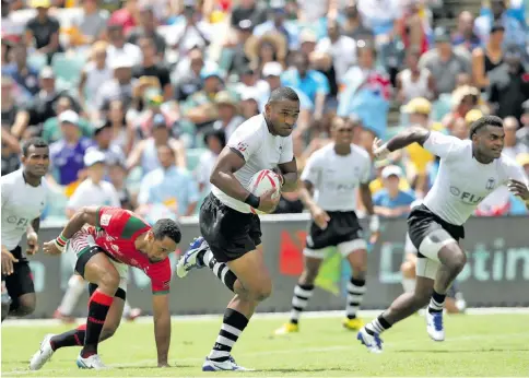  ?? Zimbio ?? Isake Katonibau (with ball) on the attack for Fiji Airways Fijian 7s team. Photo: