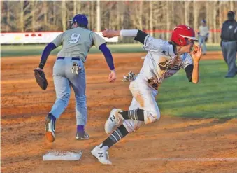  ?? STAFF PHOTO BY DOUG STRICKLAND ?? Signal Mountain runner Alec Woolums rounds third base after the ball gets past Grundy County third baseman Griffyn Rogers during their high school baseball game Thursday on Signal’s field. Woolums scored the deciding run in a 4-3 win.