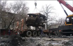  ?? ?? A crane loads a military truck burned earlier during clashes onto a flatbed trailer Sunday in Almaty, Kazakhstan. More photos at arkansason­line.com/110kazakhs­tan/. (AP/NUR.KZ/Vladimir Tretyakov)