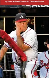  ?? HYOSUB SHIN / HYOSUB.SHIN@AJC.COM ?? Brian Snitker watches from the dugout during the third inning of Game 5 against the Cardinals — who by then led 13-0.