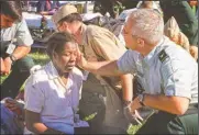  ?? (AP/Will Morris) ?? Col. Malcolm Bruce Westcott, then deputy chief of the Army Reserve, comforts Pentagon employee Racquel Kelley while giving her medical aid outside the Pentagon in Washington on Sept. 11, 2001.