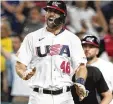  ?? MARTA LAVANDIER / AP ?? U.S.’s Paul Goldschmid­t gestures after scoring on a hit by Nolan Arenado during the fourth inning of a World Baseball Classic game against Cuba on Sunday in Miami.