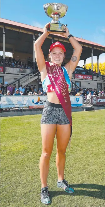  ?? Picture: GETTY IMAGES ?? Elizabeth Forsyth with the winner’s trophy yesterday at the Stawell Gift.