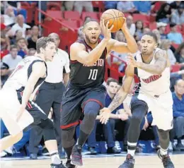  ?? WILFREDO LEE/AP ?? Heat guards Goran Dragic, left, and Rodney McGruder defend against Houston Rockets guard Eric Gordon (10) Tuesday night in Miami.