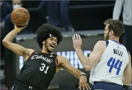  ?? TONY DEJAK — THE ASSOCIATED PRESS ?? Jarrett Allen tries to pass the ball as the Mavericks’ Nicolo Melli defends during the first half at Rocket Mortgage FieldHouse.