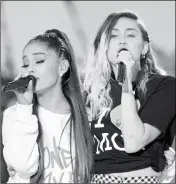  ?? DAVE HOGAN VIA AP ?? IN THIS HANDOUT PHOTO PROVIDED BY DAVE HOGAN FOR ONE LOVE MANCHESTER, SINGERS ARIANA GRANDE (left) and Miley Cyrus perform at the One Love Manchester tribute concert in Manchester, England, on Sunday. One Love Manchester is raising money for those...