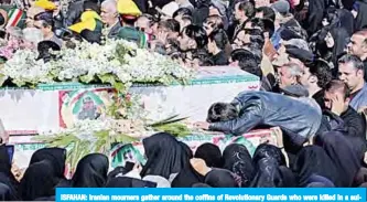  ?? —AFP ?? ISFAHAN: Iranian mourners gather around the coffins of Revolution­ary Guards who were killed in a suicide attack, during their funeral in southeaste­rn city of Isfahan.