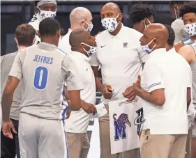  ?? JOE RONDONE/THE COMMERCIAL APPEAL ?? Memphis coach Penny Hardaway listens to assistant Jermaine Johnson during a timeout in a game in December 2020.