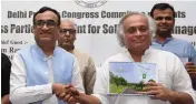  ?? — BIPLAB BANERJEE ?? Delhi Congress president Ajay Maken with party leader Jairam Ramesh release the roadmap for sanitation and solid waste management during a conference in New Delhi on Sunday.