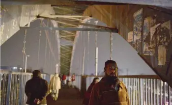  ?? AFP ?? People walk across a bridge during a nationwide power outage in Islamabad on Tuesday. —