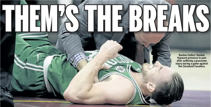  ?? TONY DEJAK/AP ?? Boston Celtics’ Gordon Hayward grimaces in pain after suffering a gruesome injury during a game against the Cleveland Cavaliers.