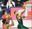  ?? Ashley Landis / Associated Press ?? The Celtics’ Jayson Tatum, right, goes up for a shot agaisnt the 76ers on Monday.