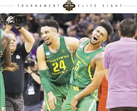  ?? Ronald Martinez/Getty Images ?? Dillon Brooks, left, and Tyler Dorsey celebrate Oregon’s upset of Midwest Region No. 1 seed Kansas Saturday.