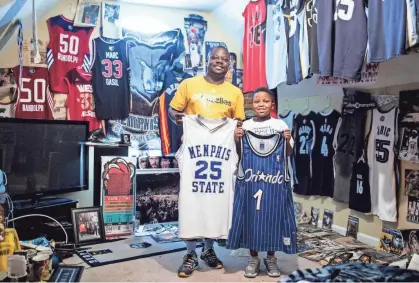  ??  ?? Antonio Braxton Sr. and his son, Antonio Braxton Jr., show off two of their favorite Penny Hardaway jerseys from their collection of Memphis sports memorabili­a. PHOTOS BY BRAD VEST/THE COMMERCIAL APPEAL