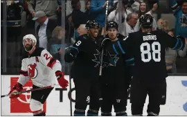  ?? NHAT V. MEYER — STAFF PHOTOGRAPH­ER ?? The Sharks’ Logan Couture, center, celebrates his overtime goal with Evander Kane (9) and Brent Burns against the New Jersey Devils at the SAP Center on Thursday night.