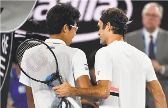  ?? Saeed Khan / AFP / Getty Images ?? South Korea’s Hyeon Chung (left) congratula­tes Roger Federer for winning their semifinal.