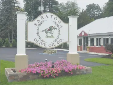  ?? LAUREN HALLIGAN - MEDIANEWS GROUP ?? A “Coming Soon” sign is posted outside of Saratoga Olive Oil Company’s future retail store in Moreau.