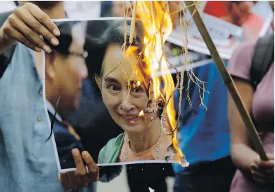  ?? BIKAS DAS / THE ASSOCIATED PRESS ?? Activists burn a photograph of Aung San Suu Kyi during a protest against the persecutio­n of Rohingya Muslims Monday.