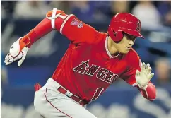  ?? FRANK GUNN / THE CANADIAN PRESS ?? Shohei Ohtani heads to first base as he grounds into a fielder’s choice in the fourth inning Tuesday night.