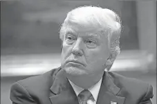  ??  ?? President Donald Trump listens during a meeting with the National Associatio­n of Manufactur­ers on Friday in the Roosevelt Room of the White House in Washington.