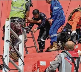  ?? U.S. COAST GUARD ?? A rescue team helps a crew member of the capsized Golden Ray on Monday afternoon. He was one of four remaining crew members on the ship.