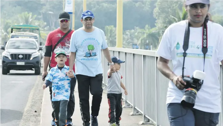  ?? Photo: ?? Acting Prime Minister and Attorney General, Aiyaz Sayed-Khaiyum with his two sons... Ibrahim and Idris at the Outrigger Walk for Kids 2018 in Sigatoka on April 21, 2018.