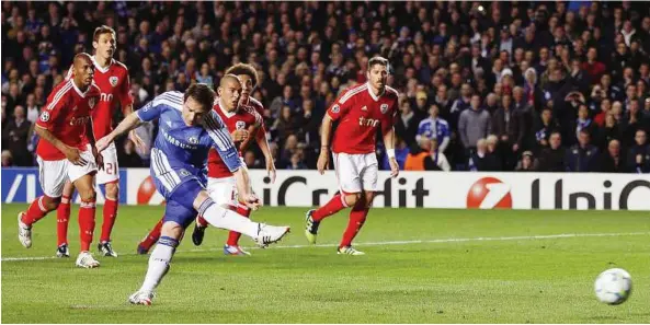  ??  ?? Blast off: Chelsea’s Frank Lampard scores from the penalty spot against Benfica during their Champions League quarter-final second leg match at Stamford Bridge on Wednesday. — Reuters