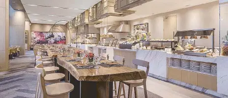  ??  ?? Sharing is caring: All-day dining Misto has a show kitchen, various stations, and an extensive buffet plus communal tables for groups and individual­s who wish to share meals in this age of shared office spaces and ride sharing.