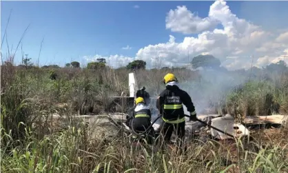  ?? Photograph: Tocantins State Firefighte­rs Handout/EPA ?? Firefighte­rs at the crash site in the northern state of Tocantins. The plane was consumed by fire.