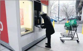  ?? ANTONIO PEREZ/CHICAGO TRIBUNE ?? Customer Jason Burley on Jan. 8 uses the Jewel-Osco kiosk pick up, 1224 S. Wabash in Chicago.