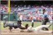  ?? CHRIS SZAGOLA — THE ASSOCIATED PRESS ?? Arizona Diamondbac­ks catcher Chris Herrmann, left, tags out Philadelph­ia Phillies’ Freddy Galvis, center, as he tried to score in the sixth inning of a baseball game, Sunday in Philadelph­ia. The Diamondbac­ks won 5-4 in 10 innings.