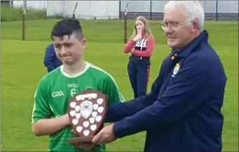  ??  ?? Captain Seán O’Sullivan of the Ballyduff U-14 hurling team receiving the County league Division 1 trophy from Tadhg O’Halloran at Causeway on Saturday. Photo by Moss Joe Browne