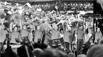  ??  ?? Najib and other Umno leaders wave BN flags at the launch of JR Plus at the Putra World Trade Centre. — Bernama photo