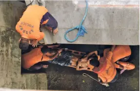  ?? ?? PERSONNEL of the Andhra Pradesh State Disaster Response Force rescue a youth who jumped off Prakasam Barrage in Vijayawada on July 7, 2022.