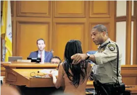  ?? Mike Kepka / The Chronicle ?? Gypsy Taub strips and is escorted out during a public hearing on legislatio­n proposed by Supervisor Scott Wiener that would ban nudity in public streets.