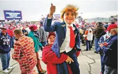  ?? AP ?? A young Trump fan makes heads turn at a Republican campaign rally at Erie, Pennsylvan­ia, on Tuesday.