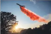  ?? Marcus Yam Los Angeles Times ?? AN AIR TANKER drops fire retardant ahead of the River fire in Mendocino County on Wednesday.