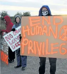  ?? ALLAN BENNER/STANDARD STAFF ?? St. Catharines resident Adam Stirr, from a group called At War for Animals Niagara, at right, joins protesters from Short Hills Wildlife Alliance and Animal Alliance of Canada at the Short Hills deer hunt on Saturday.